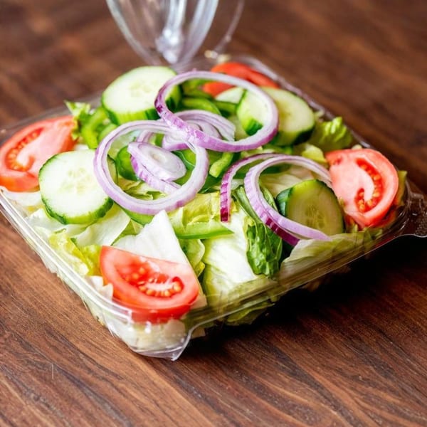 Fresh garden salad from Nicolini House of Pizza with lettuce, tomatoes, cucumbers, and red onions.